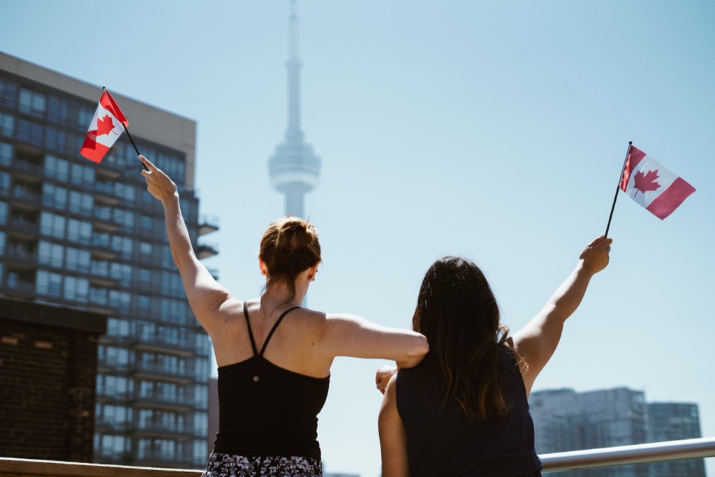 People waving the Canadian Flag